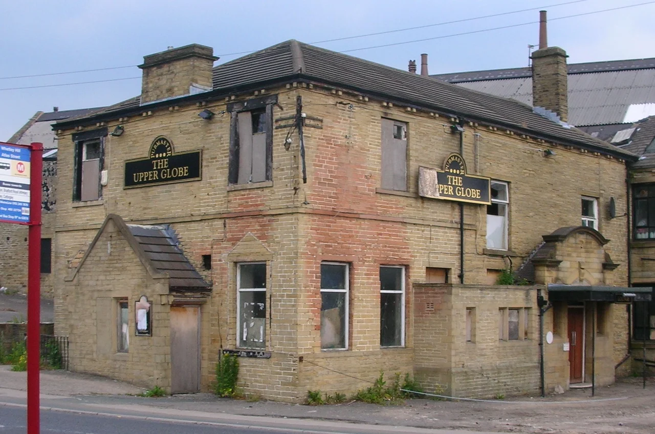 A picture of the Upper Globe pub on Toller Lane in Bradford. It was attacked during the Bradford Riots in 2001, and has since laid disused.
MGSpiller 13:12, 25 June 2006 (UTC)

This is untrue, it was damaged in the Manningham riots which were held over two days in 1995. There was a band playing there that evening who still carried on playing to scared patrons, themselves in fear but they did their best to carry on. This pub has stood empty since then. They kept patrons locked inside for their safety despite the windows being smashed, but it was less safe for them to leave.