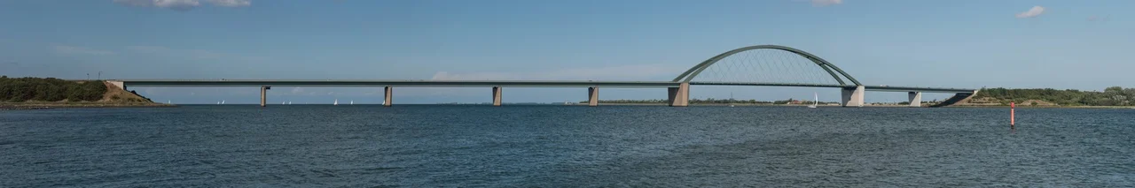 A panoramic image of the Fehmarn Sound Bridge as seen from Großenbroderfähre, located southeast of the German mainland
